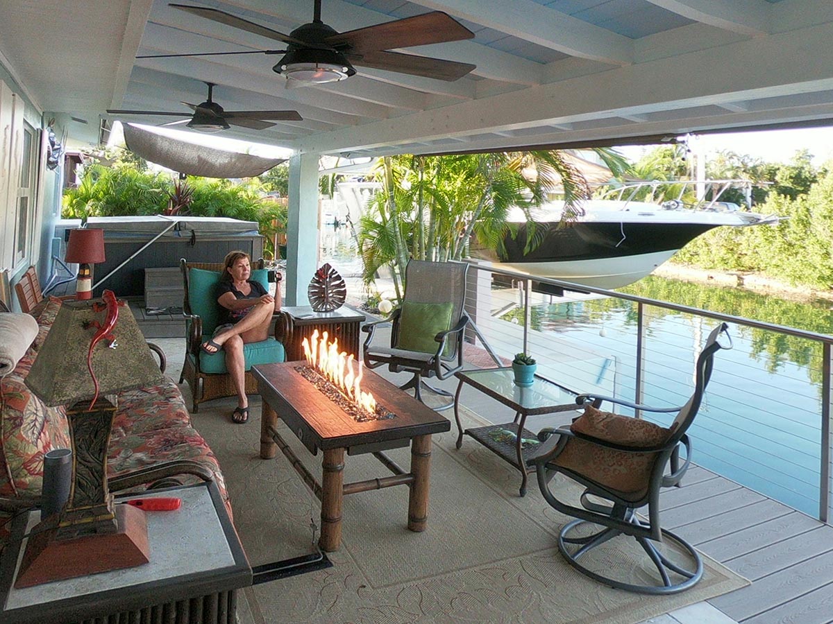 Outdoor Living Room includes lamps, fire table, fans and a private view, only ten feet from the water